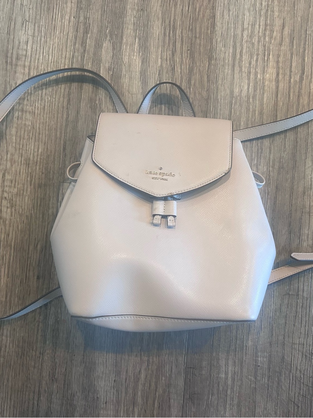 kate spade pale pink leather backpack with gold logo